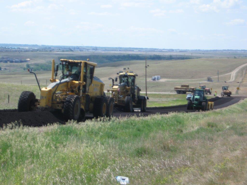 Grader and Packer working on Cypress County Roads